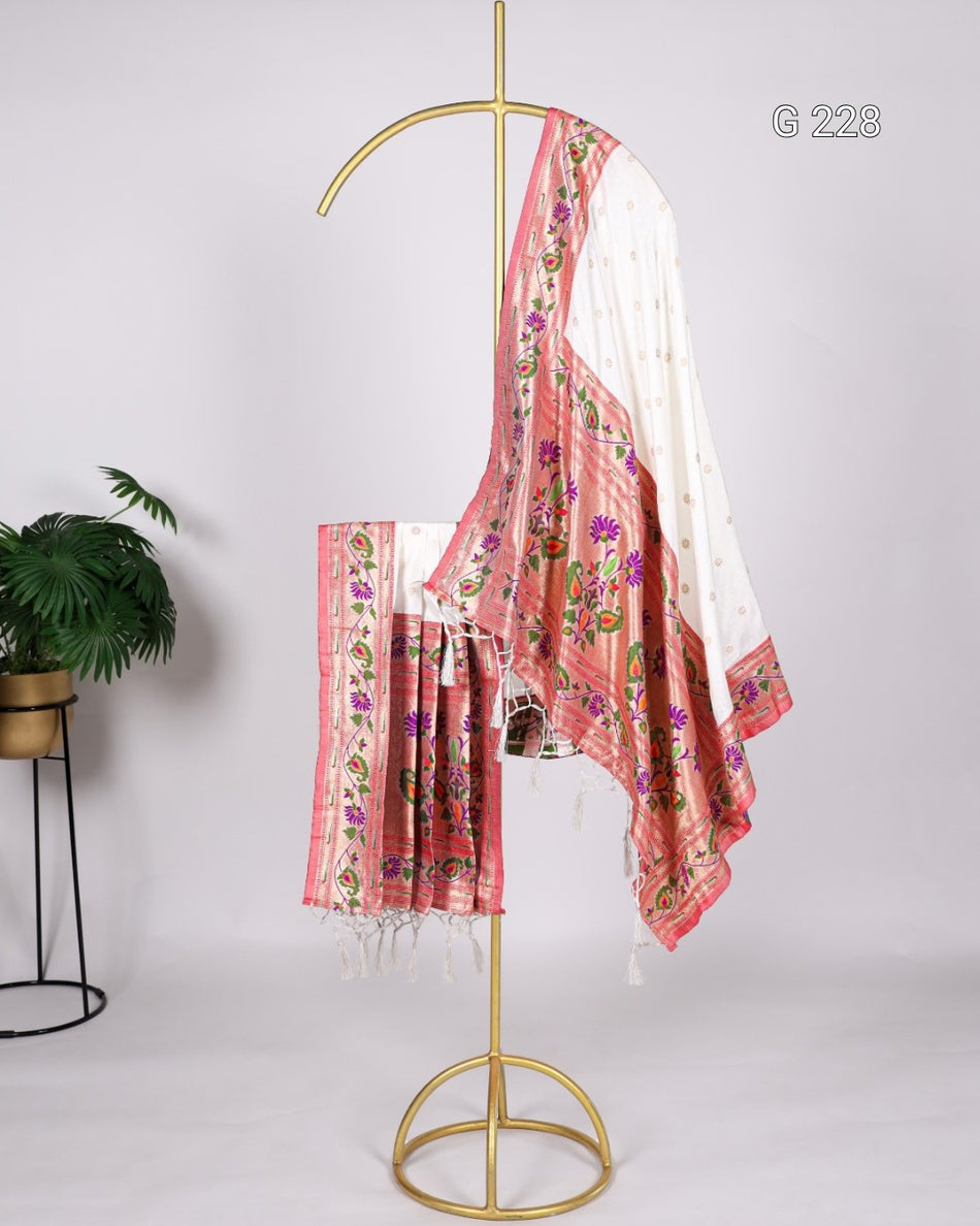 Floral patterned scarf on a gold stand against a white background