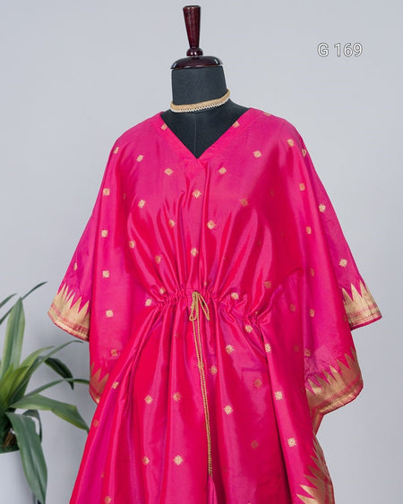 Pink dress with gold patterns on a mannequin against a gray background