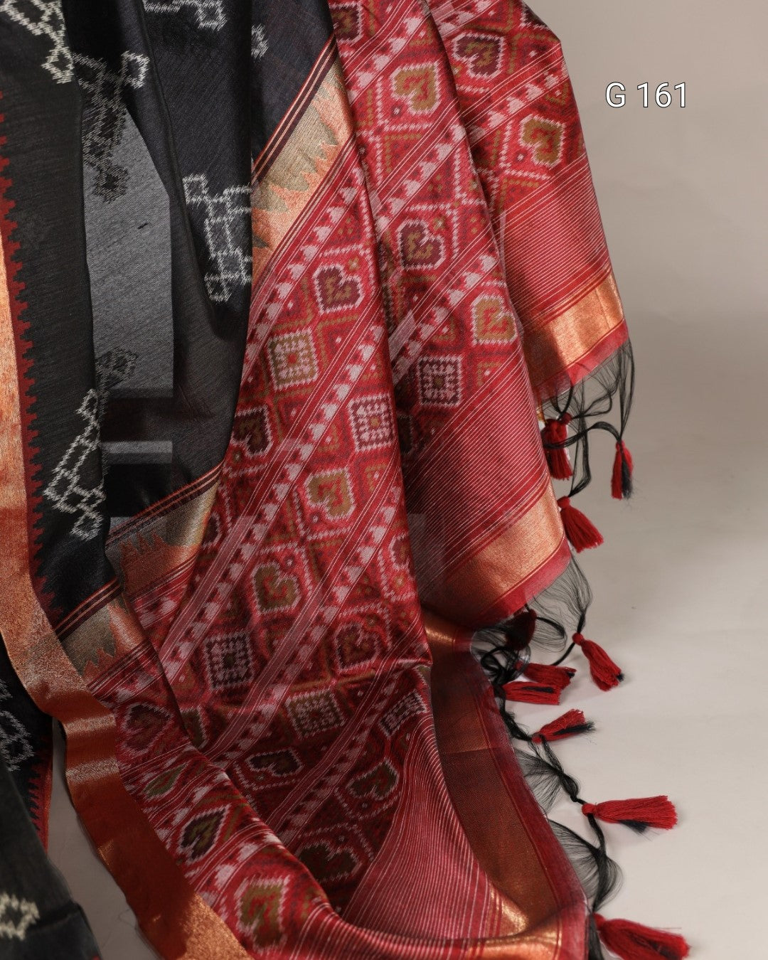 Traditional patterned fabric with tassels on a neutral background