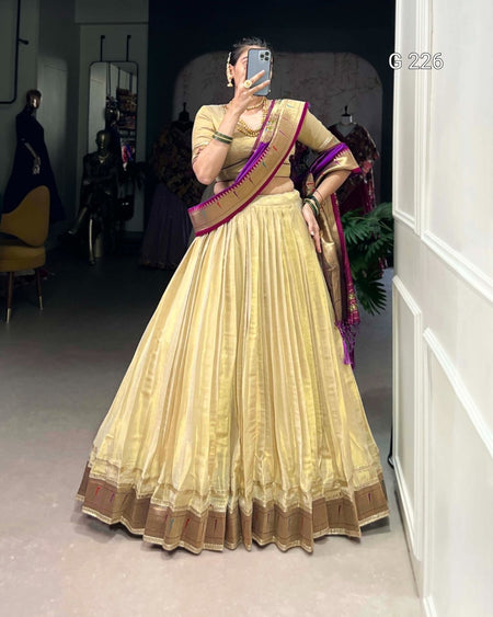 Woman wearing a traditional outfit with a mirror reflection in a room.