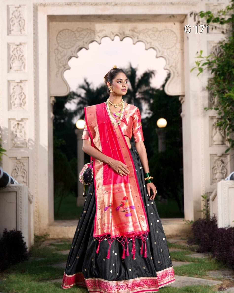 Woman in a traditional outfit standing in front of an ornate archway.