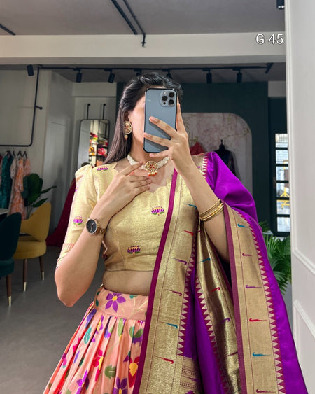 Woman taking a mirror selfie wearing a traditional outfit with a colorful saree.