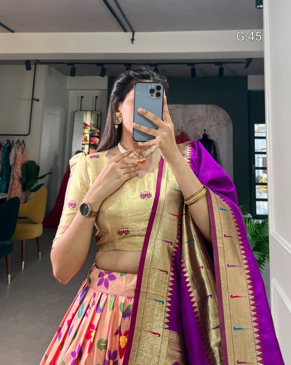 Woman taking a mirror selfie wearing a traditional outfit with a colorful saree.