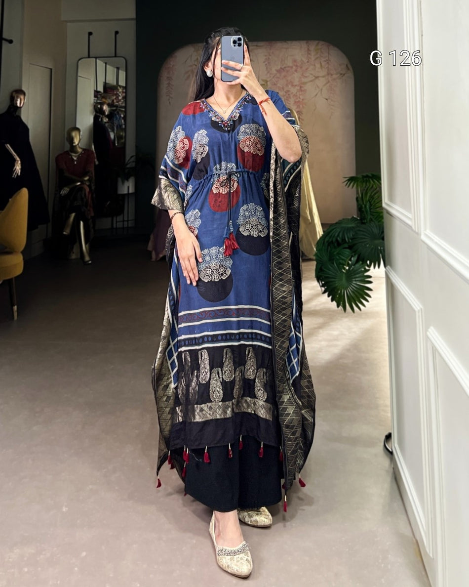 Person wearing a long, patterned dress in a room with a mirror and decor.
