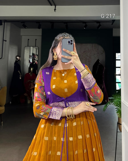 Person wearing a colorful outfit with a purple top and orange skirt, taking a mirror selfie.