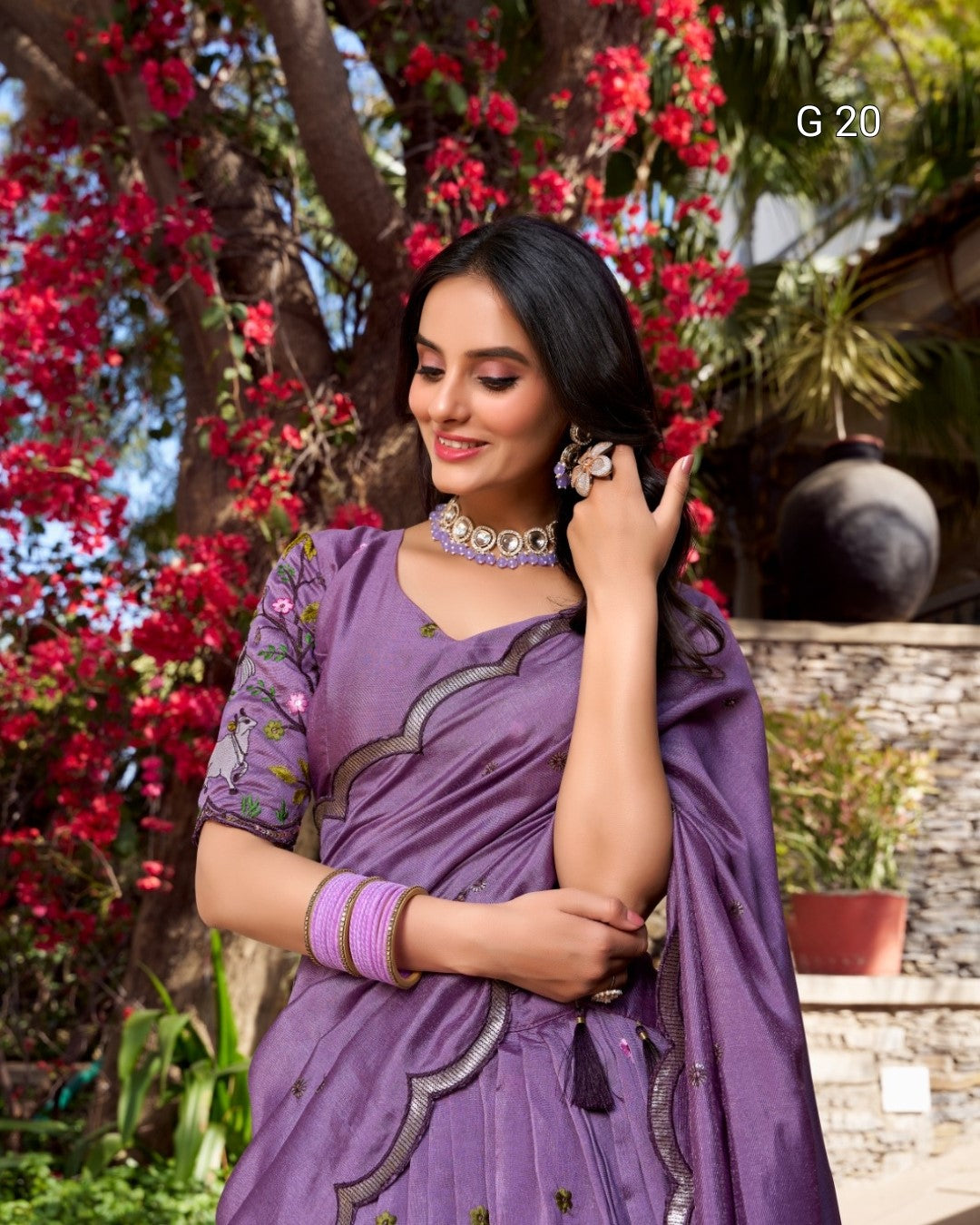 Woman in a purple saree with floral background