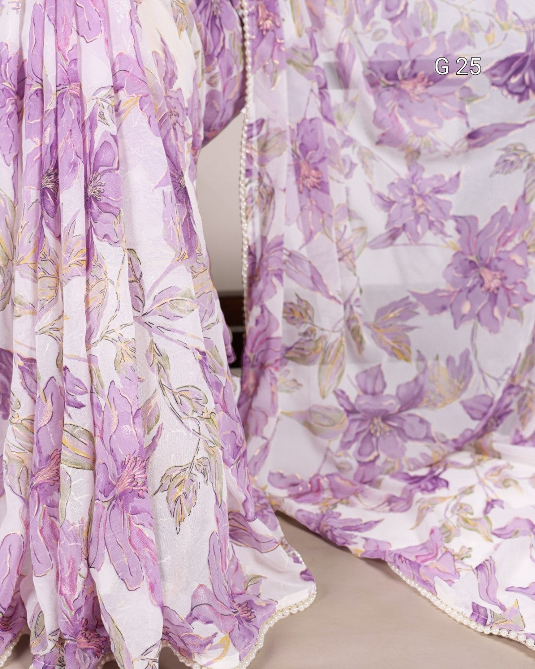 Floral patterned fabric with purple and white colors on a chair.