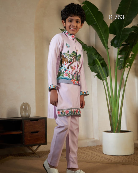 Child wearing a traditional outfit with floral embroidery in a room with a plant and wooden cabinet.