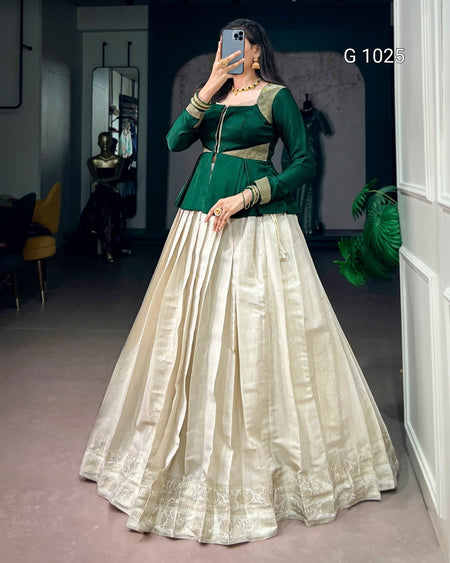 A woman takes a mirror selfie wearing a traditional Indian ethnic gown with a dark green embroidered bodice and a voluminous cream-colored flared skirt. The text 'G 1025' is visible in the top right corner.