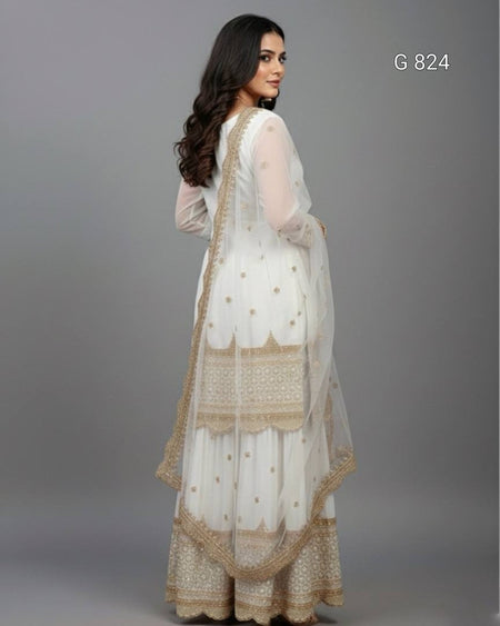 Woman wearing a white and gold traditional outfit on a gray background