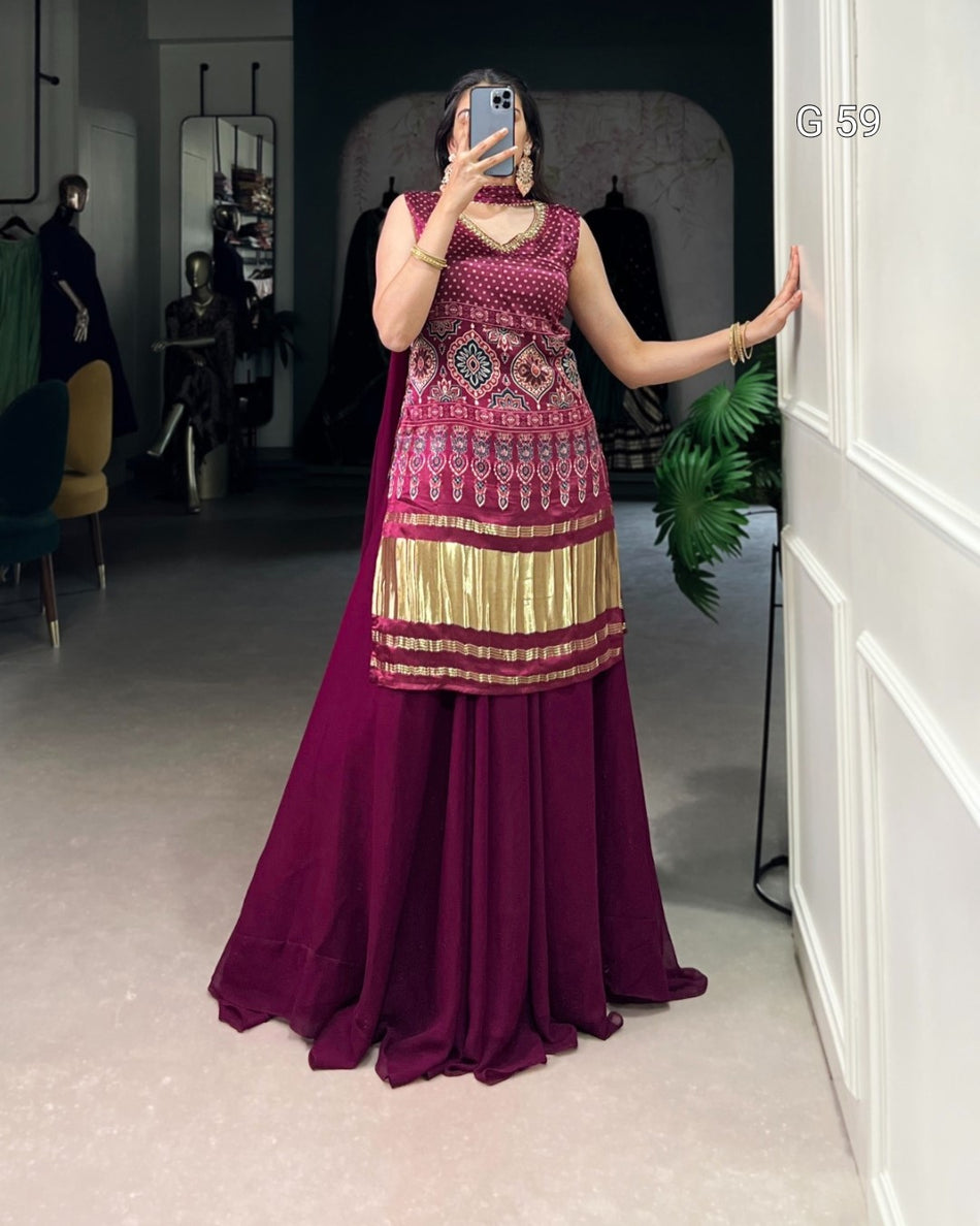 Person wearing a traditional outfit with a pink and gold top and purple skirt in a room.