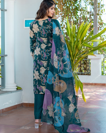 Woman wearing a floral embroidered outfit with a plant in the background