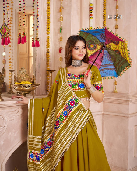Woman in a traditional outfit holding a colorful umbrella in a decorated interior setting