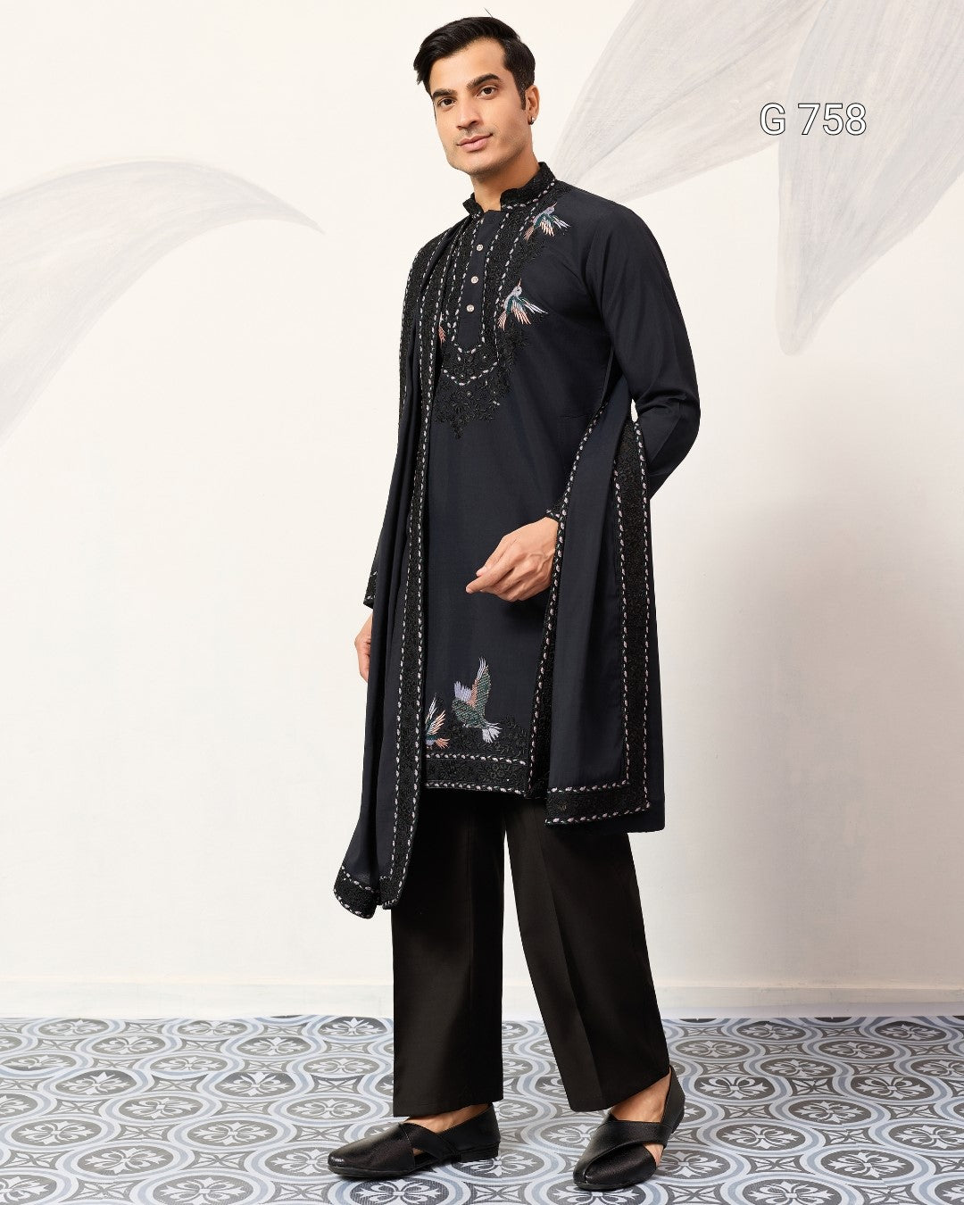 Man wearing a Navy Blue embroidered kurta with pants on a white background