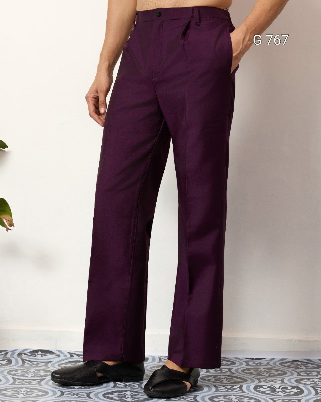 Purple pants worn by a person on a light background