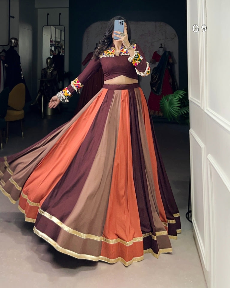 Woman wearing a colorful traditional outfit with a long skirt in a room.