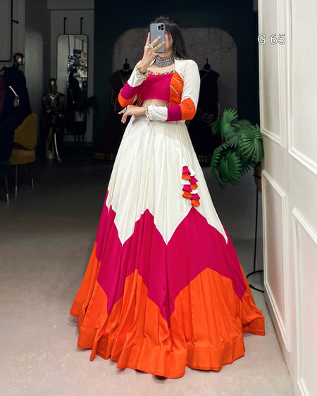 Person wearing a colorful dress with pink and orange design in a room.