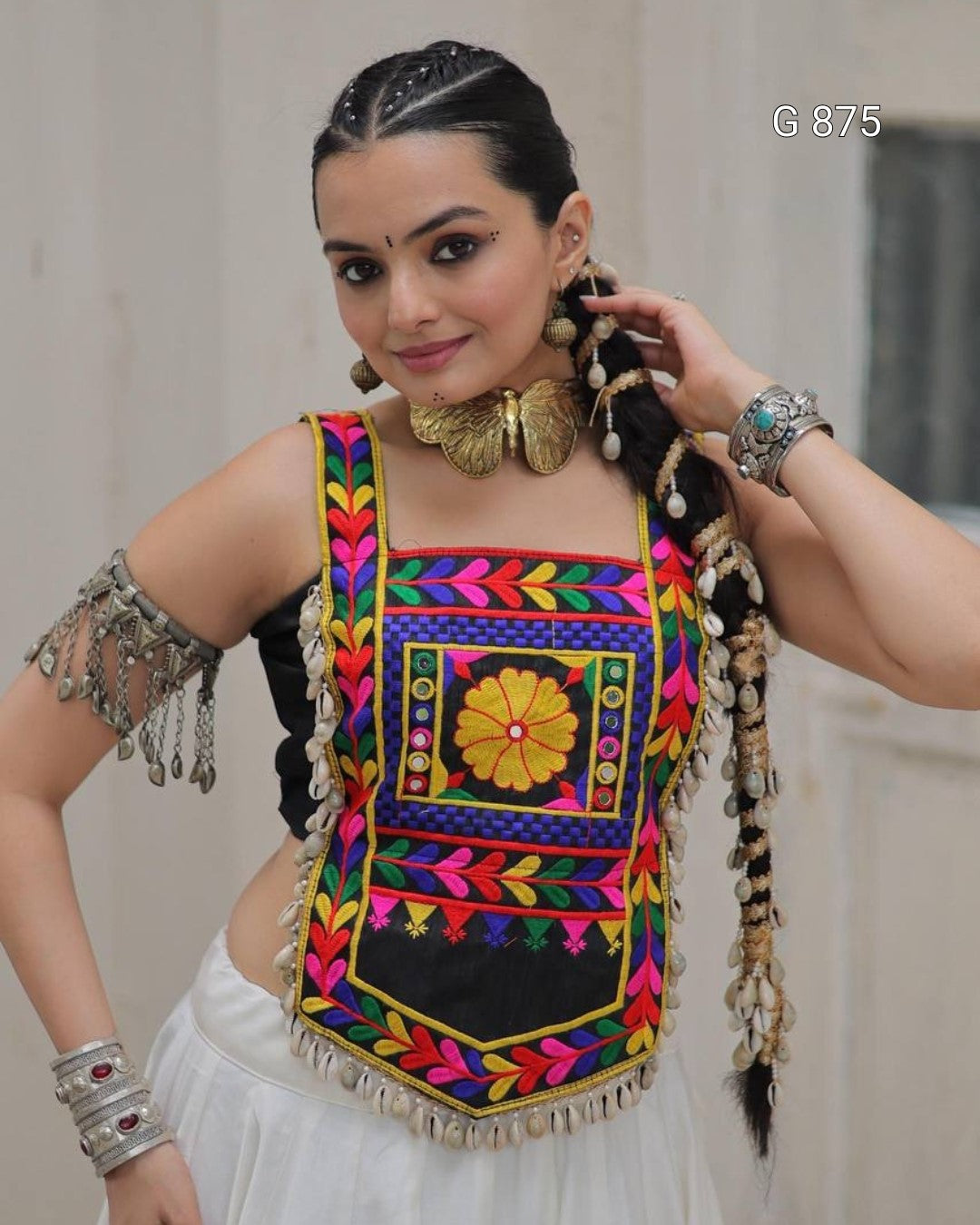 Woman wearing a colorful traditional outfit with intricate patterns and embroidery.