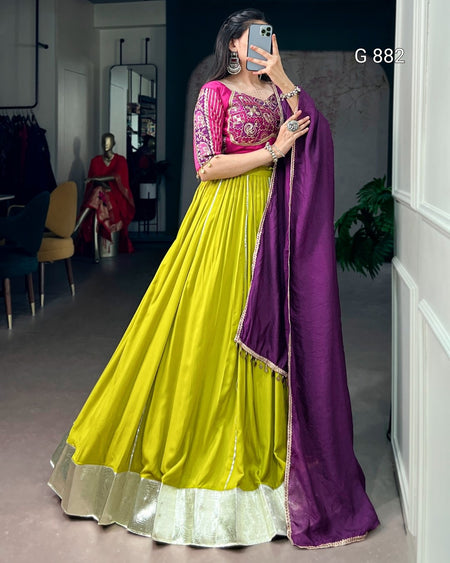 Woman in a yellow and purple traditional outfit taking a mirror selfie.