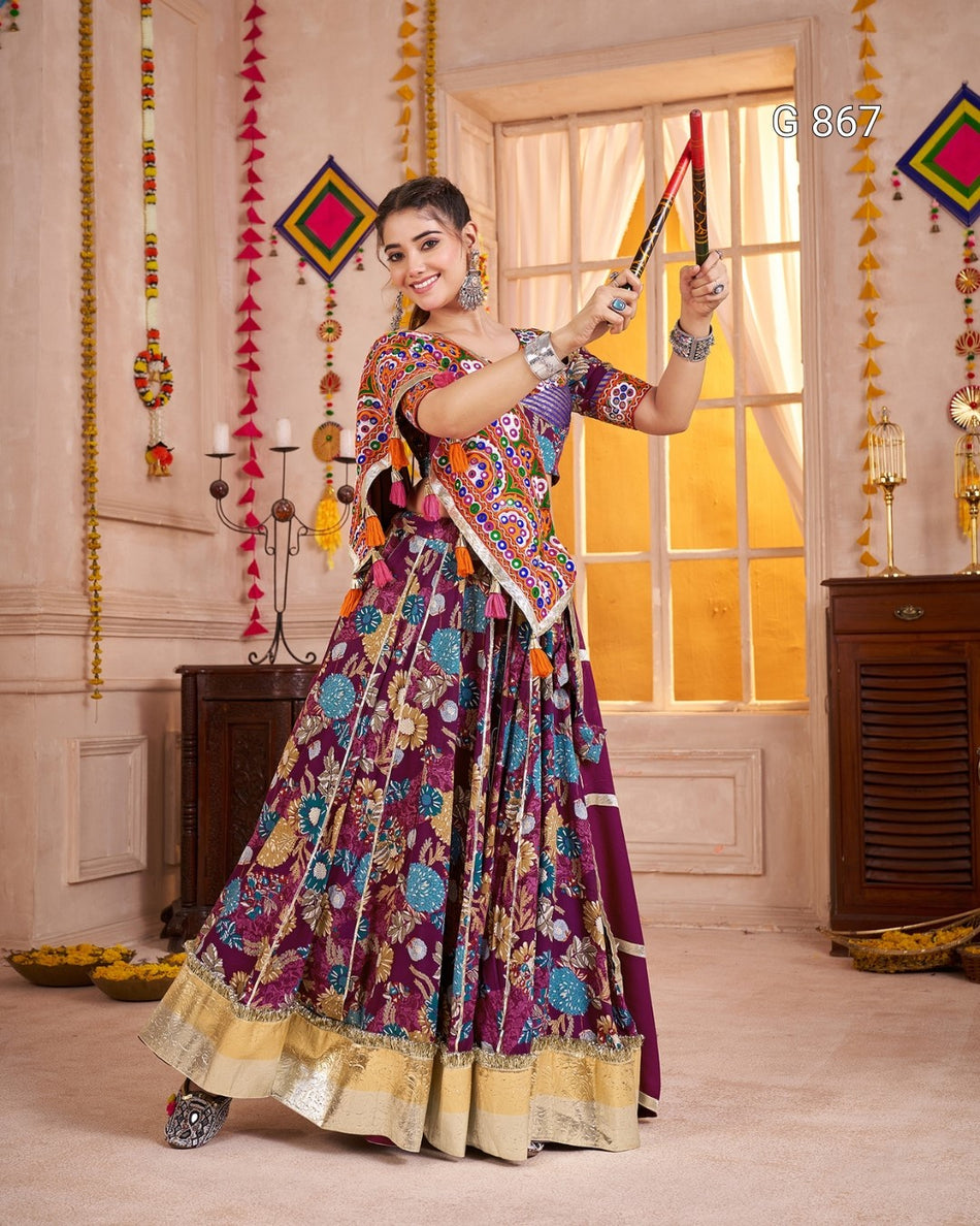 Woman in a colorful traditional outfit standing in a decorated room.