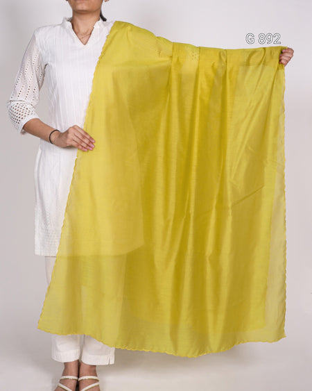 Person holding a yellow fabric against a white background