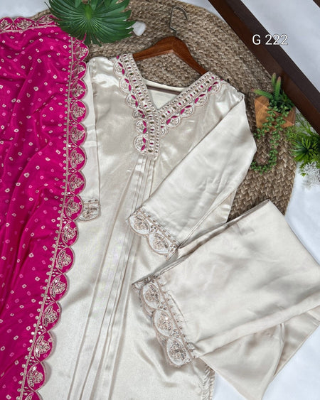 White saree with pink border and matching blouse on a textured surface