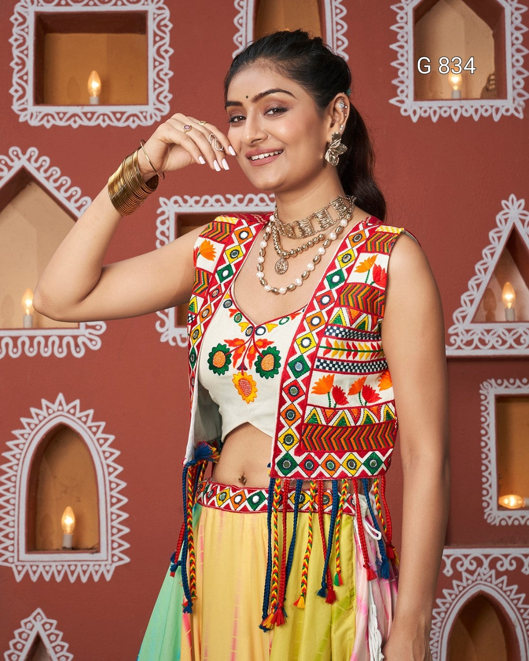 Woman wearing a colorful traditional outfit with a decorative background
