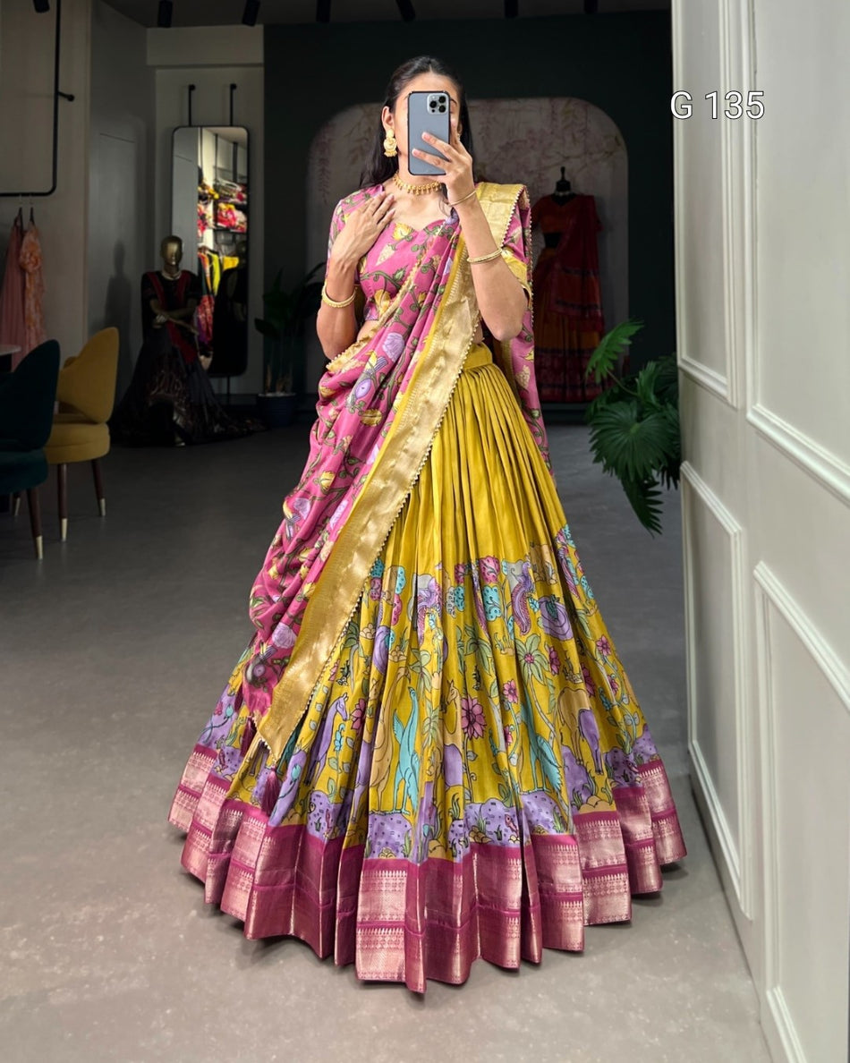 Woman wearing a colorful saree taking a mirror selfie in a room.