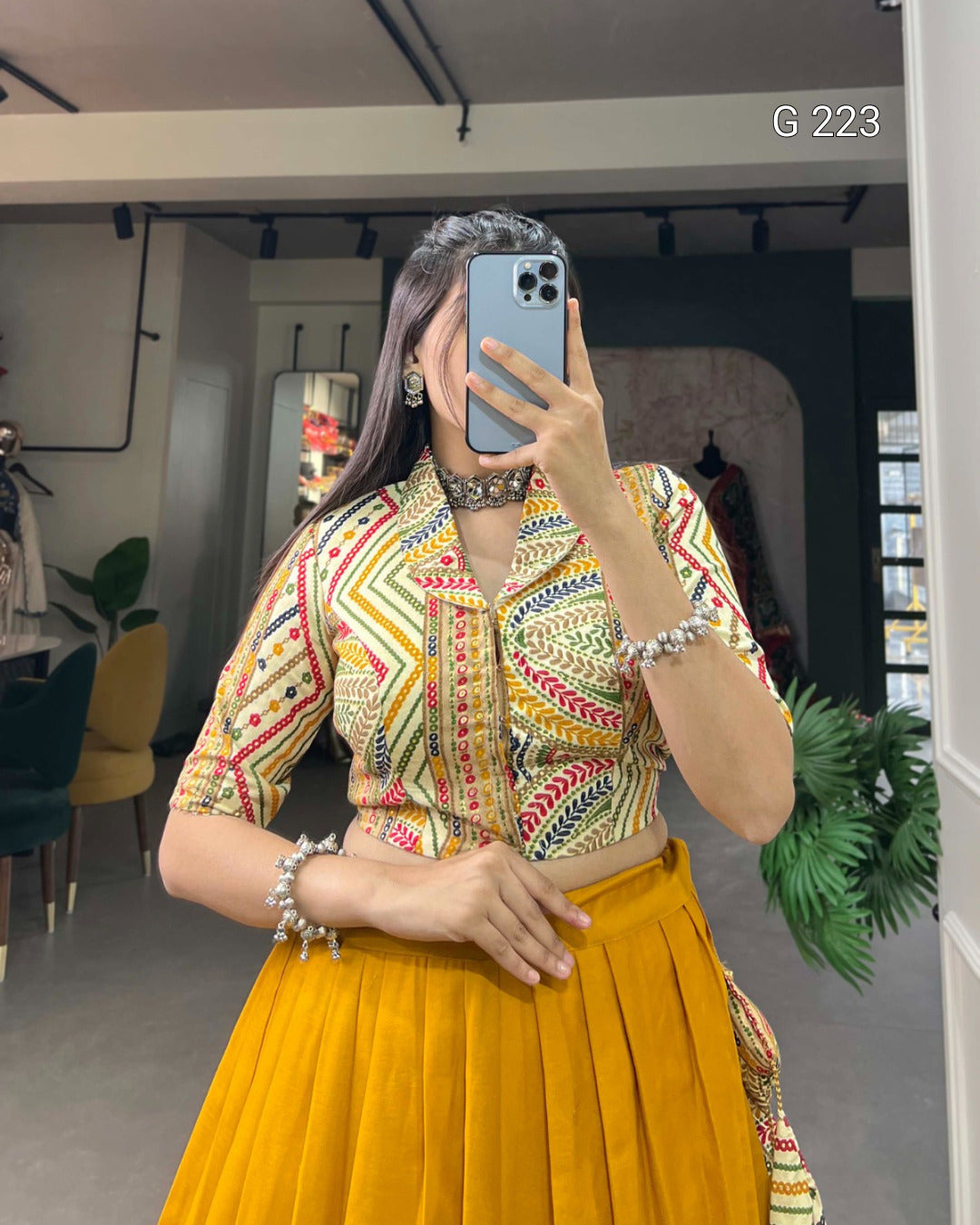 Person wearing a colorful top and yellow skirt in an indoor setting