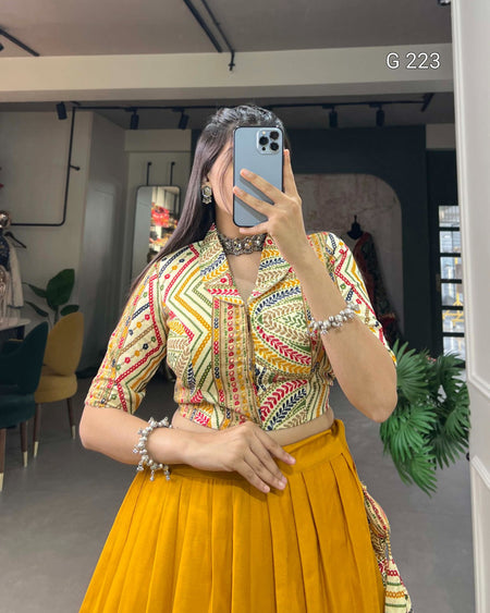 Person wearing a colorful top and yellow skirt in an indoor setting