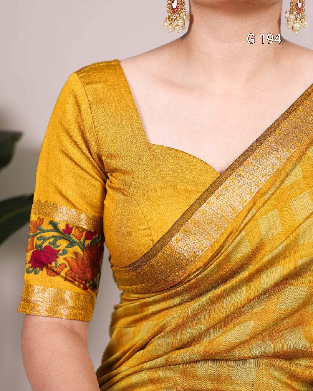 Yellow saree with floral embroidery on a plain background