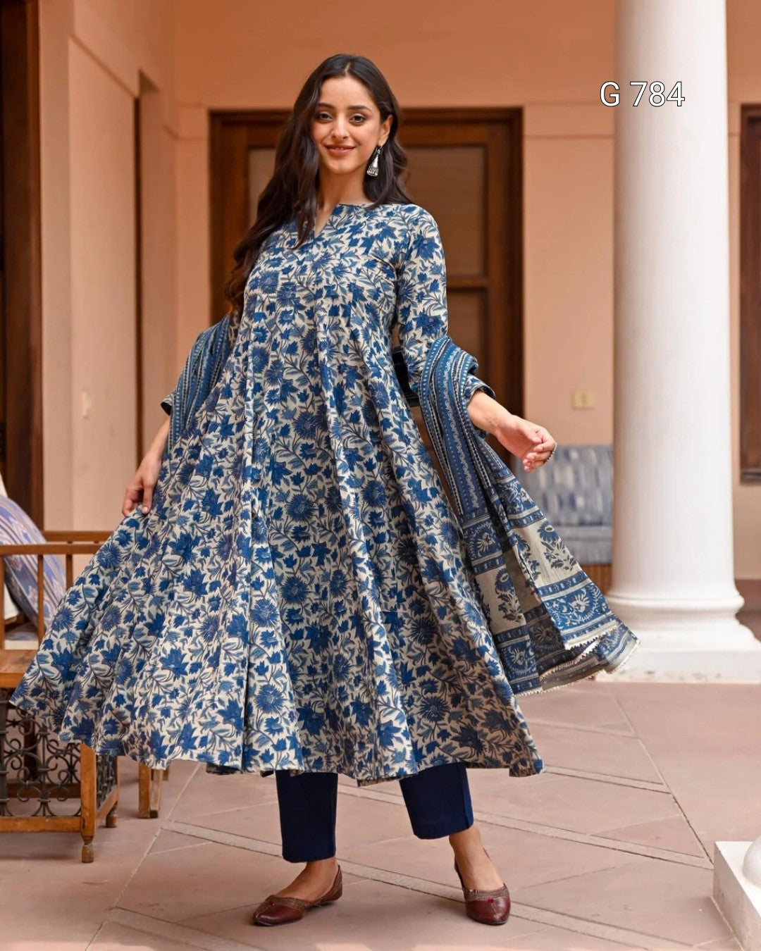 Woman wearing a blue floral dress in an outdoor setting