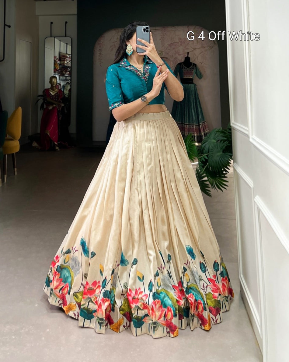 Woman taking a mirror selfie wearing a floral lehenga with a green blouse.