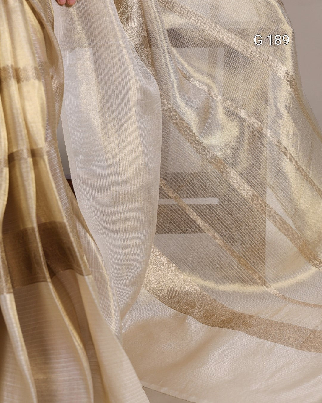 Close-up of sheer fabric with a subtle pattern, showing texture and color variations.