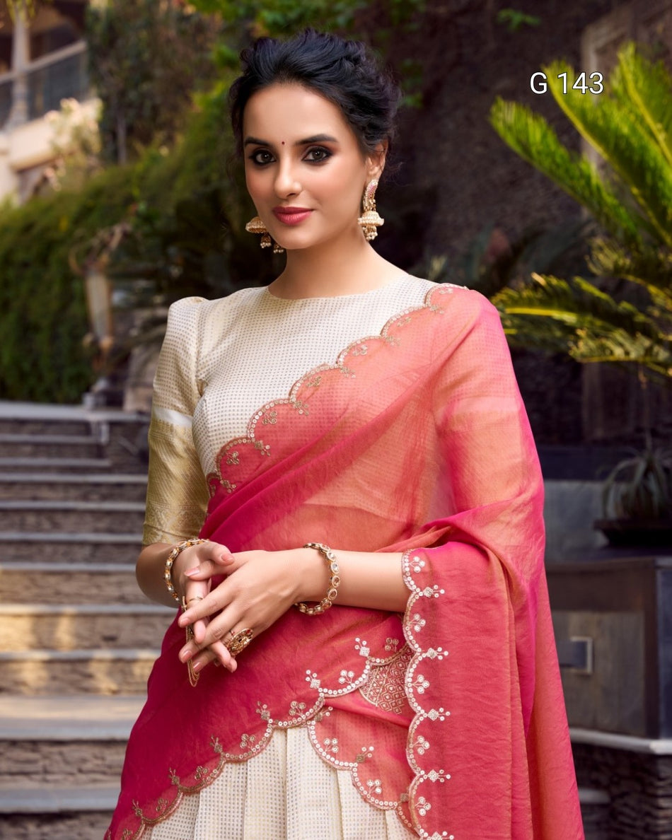 Woman wearing a pink saree with a white blouse in an outdoor setting