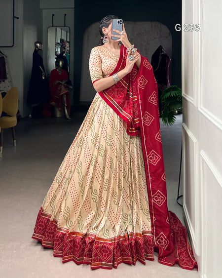 Woman in a traditional outfit with a red dupatta taking a mirror selfie.