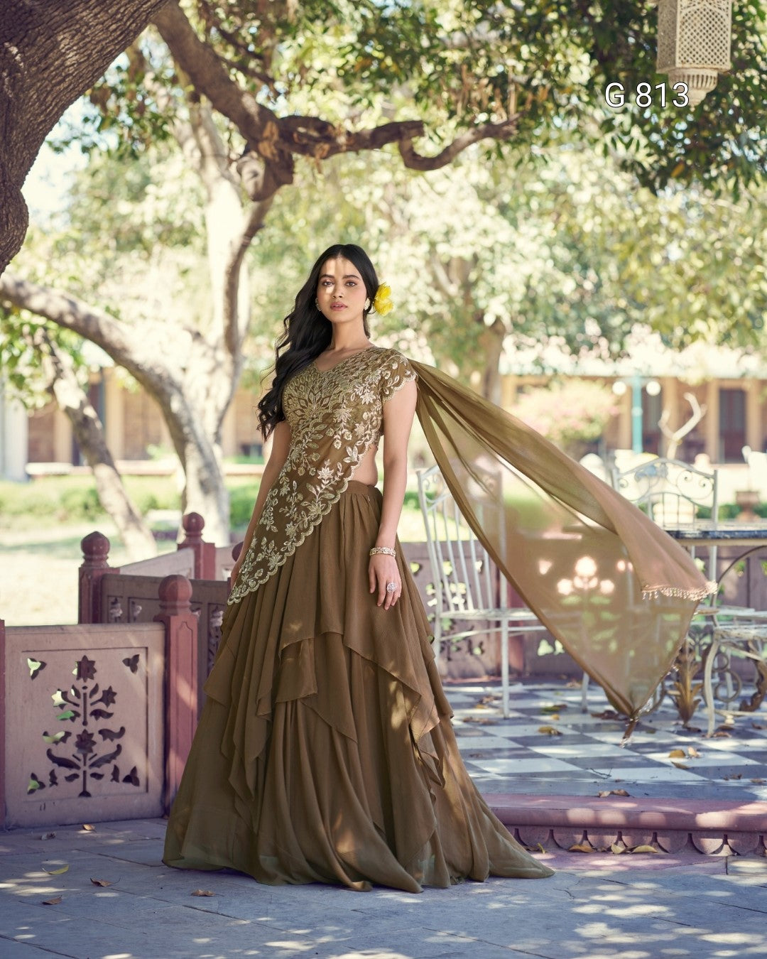 Woman in a traditional outfit standing outdoors with trees in the background