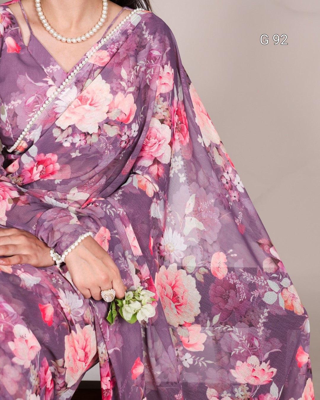 Purple floral saree with a neutral background