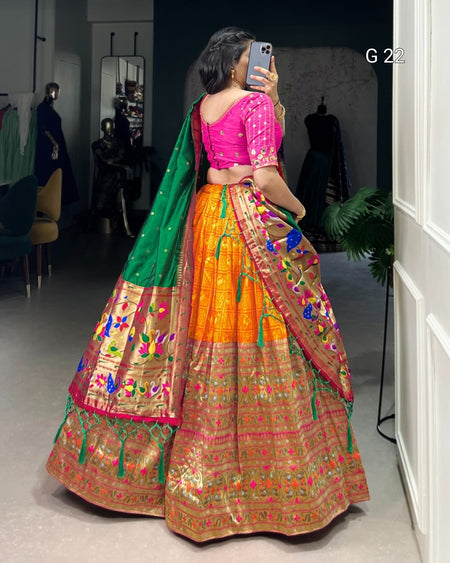Woman in a colorful traditional outfit taking a mirror selfie.