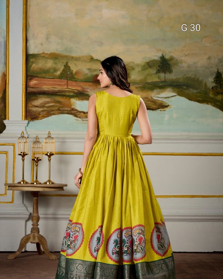 Woman in a yellow dress with floral patterns standing in a decorated room.