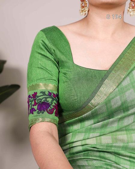 Green saree with floral patterns on a plain background