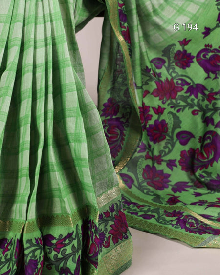 Green saree with floral patterns on a plain background