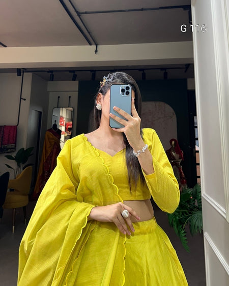 Person wearing a bright yellow outfit taking a mirror selfie.