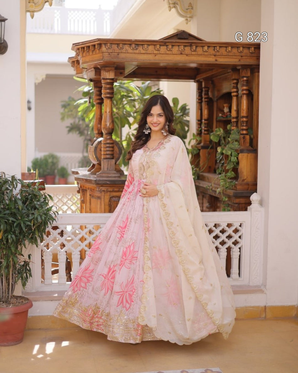 Woman in a traditional outfit standing in an elegant indoor setting with decorative elements.