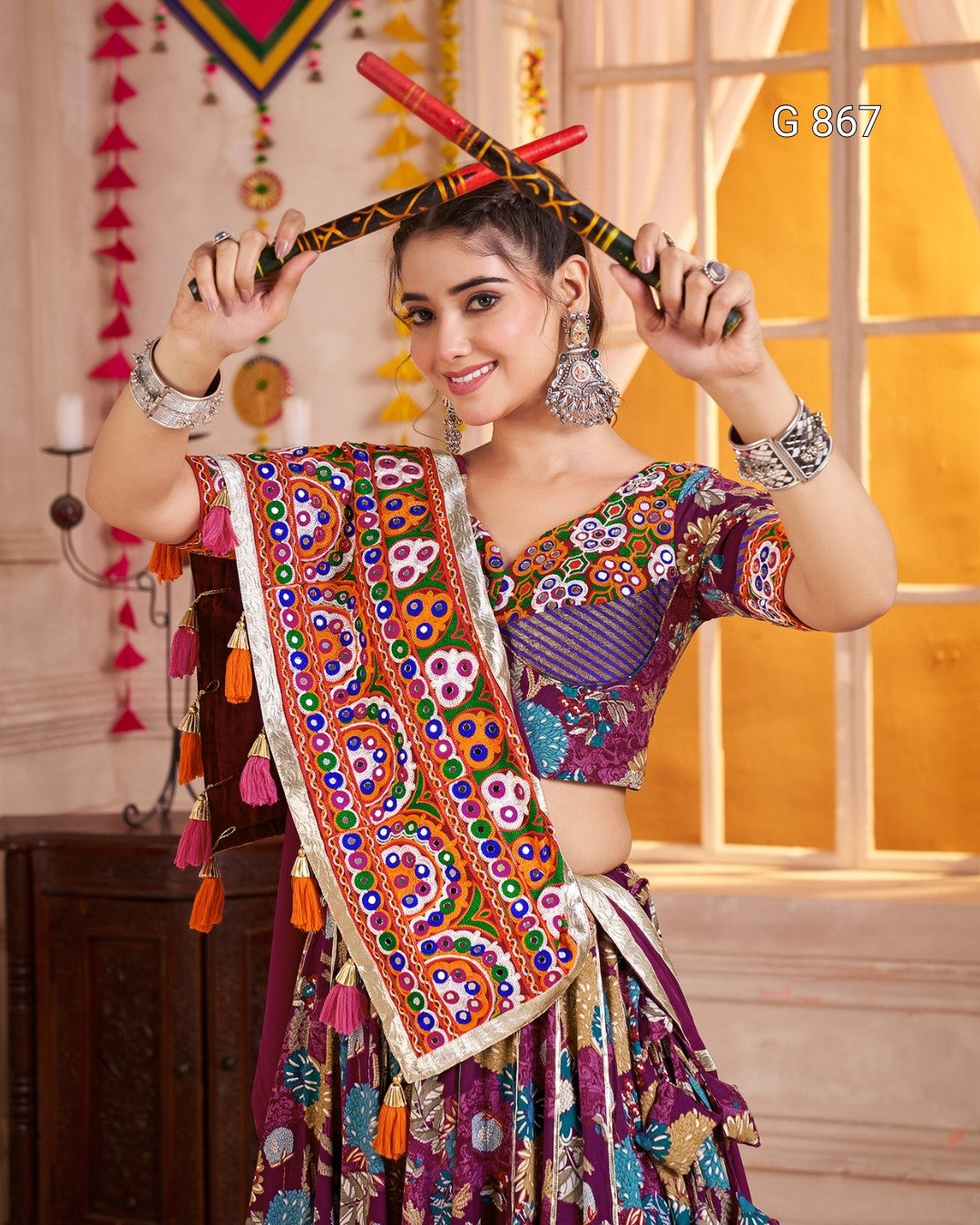 Woman in traditional colorful attire with decorative elements indoors