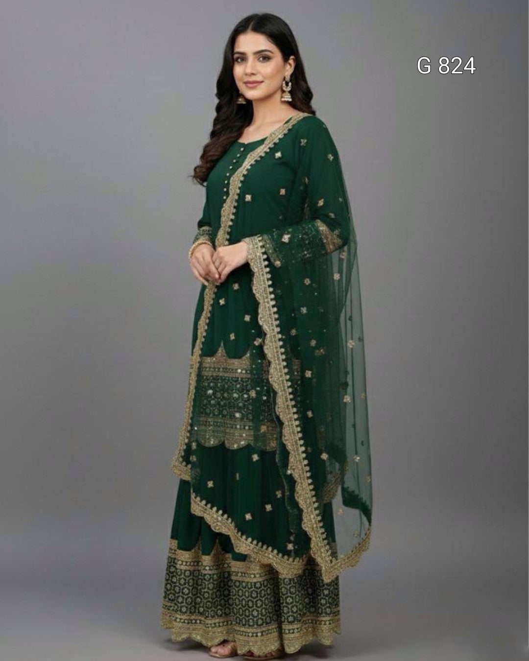 Woman wearing a green traditional outfit with gold embroidery on a gray background