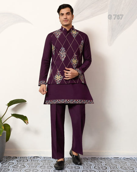 Man wearing a purple embroidered traditional outfit on a white background