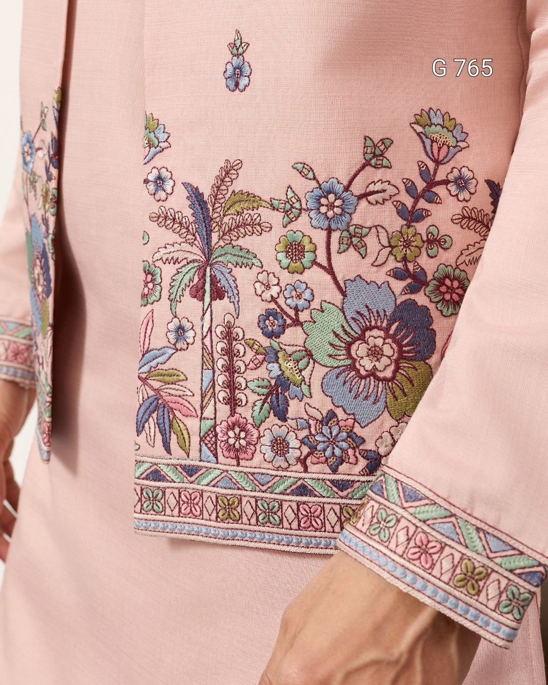 Close-up of a pink garment with intricate floral embroidery