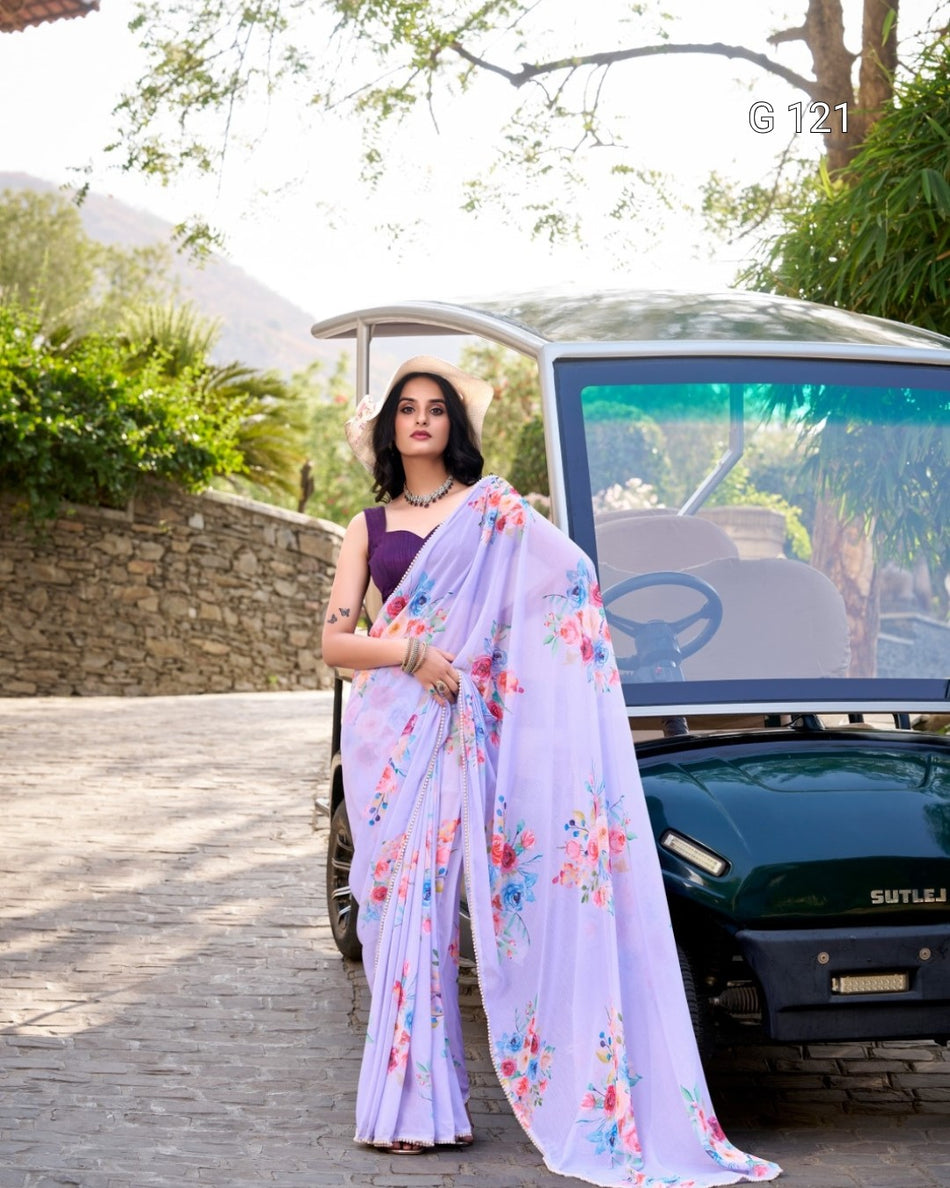 Woman in a floral saree standing next to a car with greenery in the background