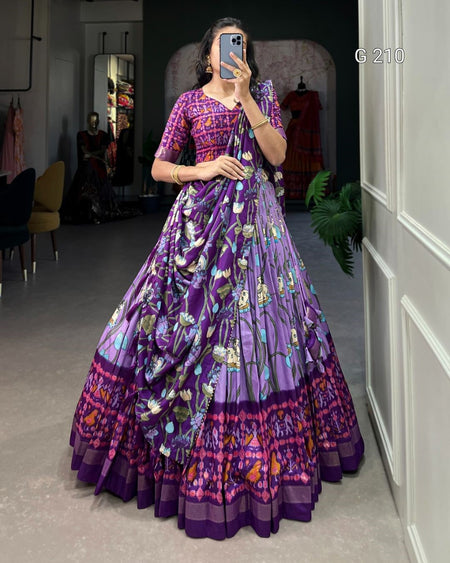 Woman in a purple floral dress taking a mirror selfie in a room.